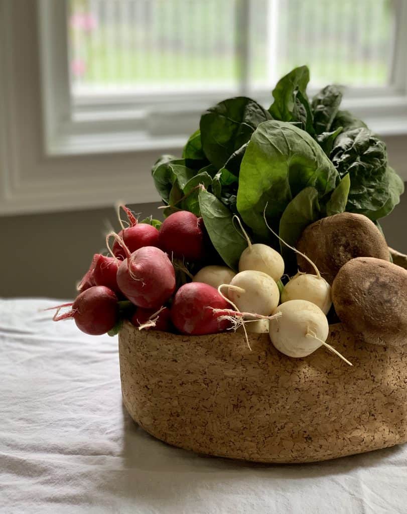 Spinach, mushrooms & radishes in a cork bowl