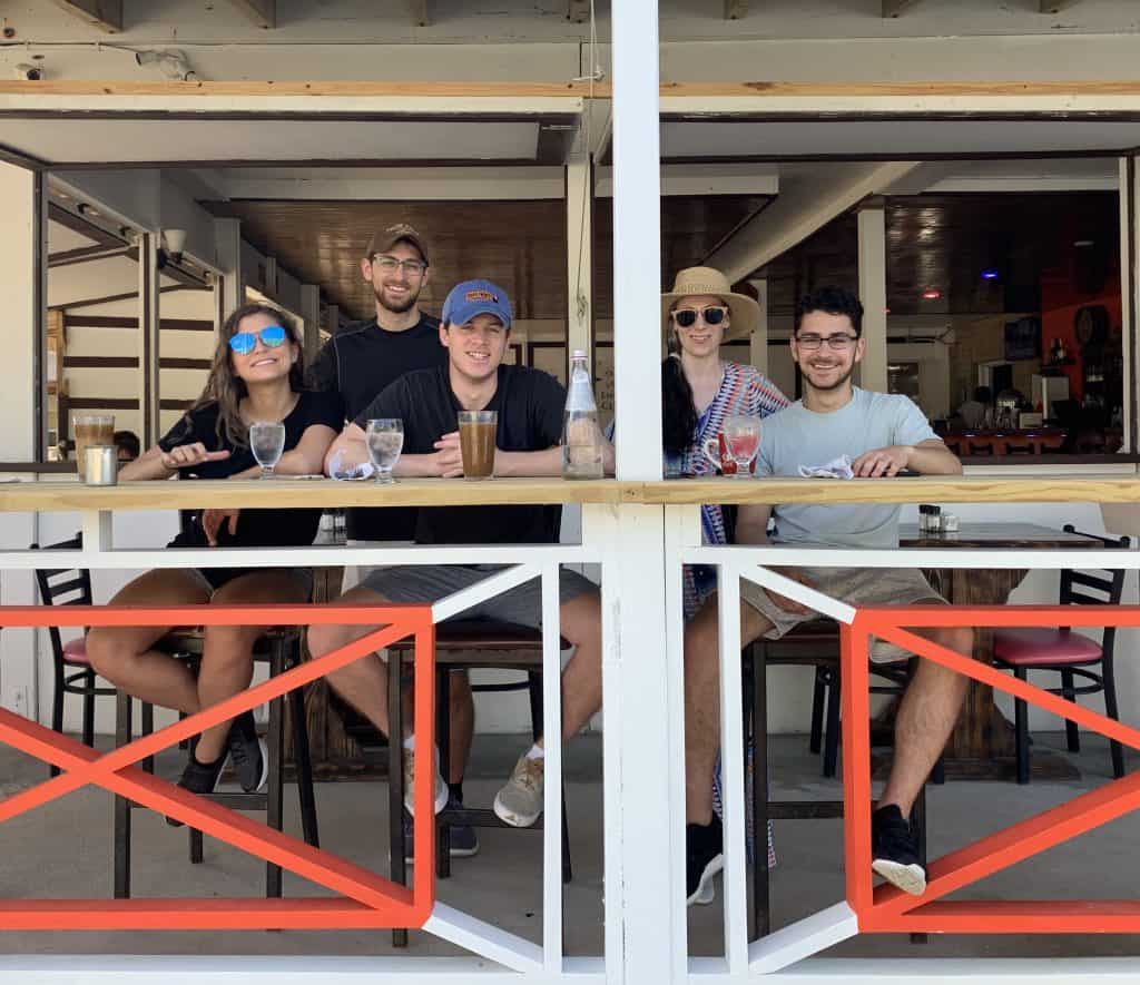 A group of people eating at an outdoor table