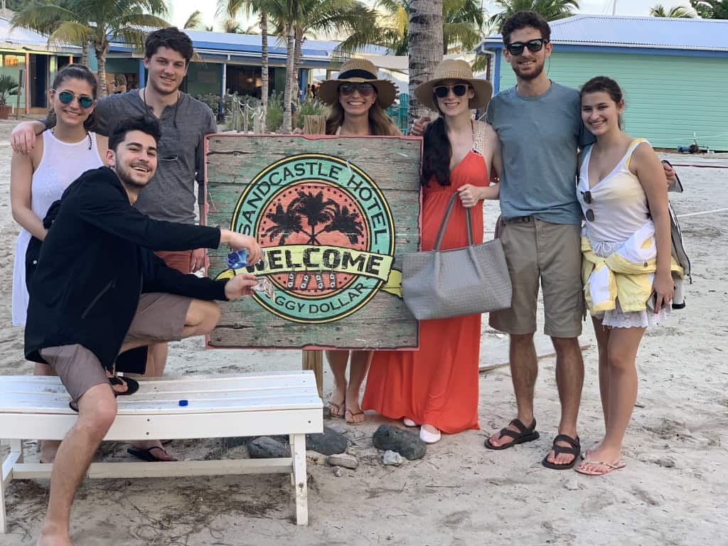 Chef Cindy and family posing at the Sandcastle Hotel sign