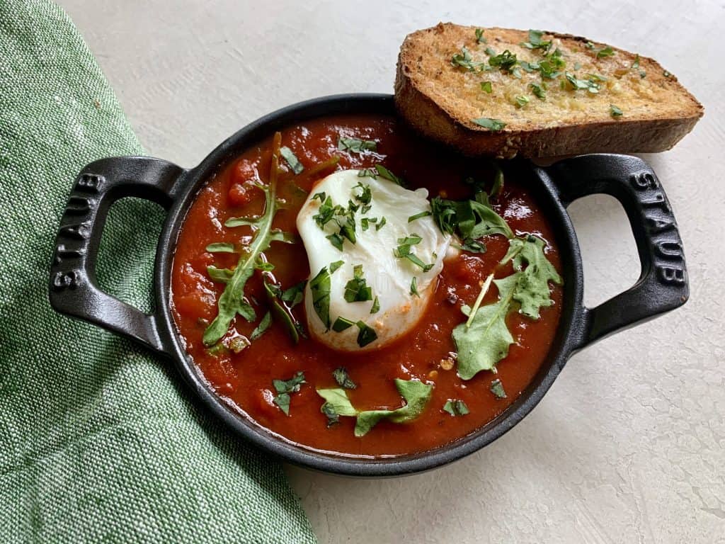 Individual serving of egg prepared in a cast-iron skillet