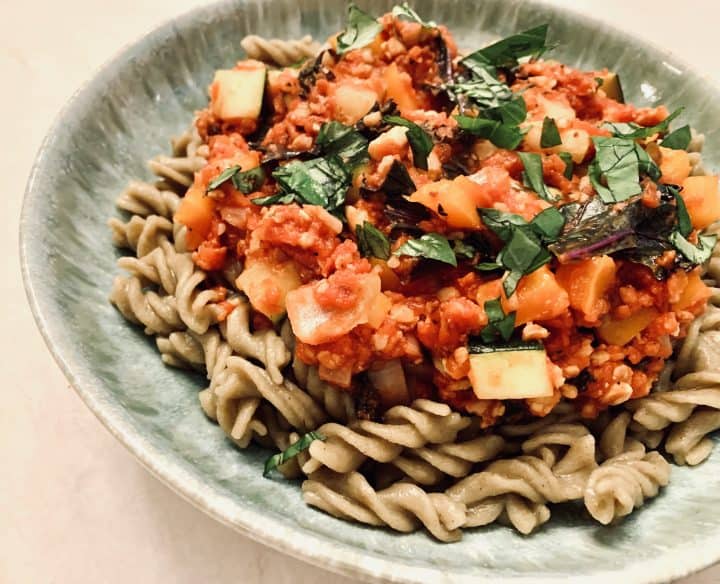 Veggie Tempeh Bolognese over mung bean pasta and topped with fresh basil.