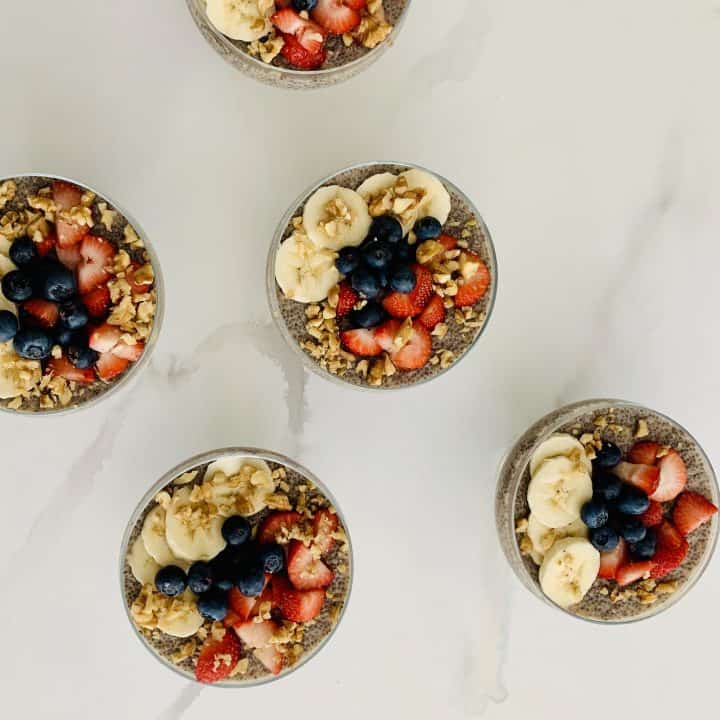 3 Lemon Chia Pudding with Berries, Bananas & Nuts in glass serving bowls