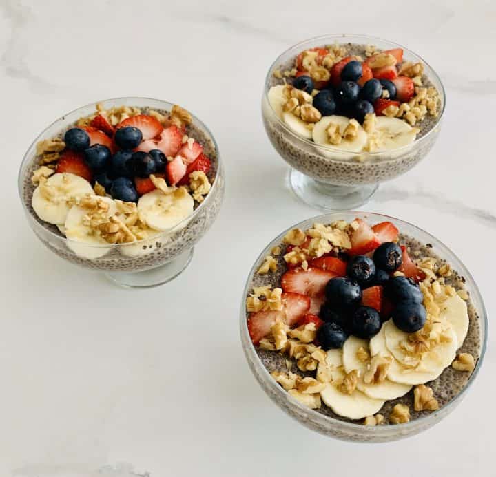 3 Lemon Chia Pudding with Berries, Bananas & Nuts in glass serving bowls