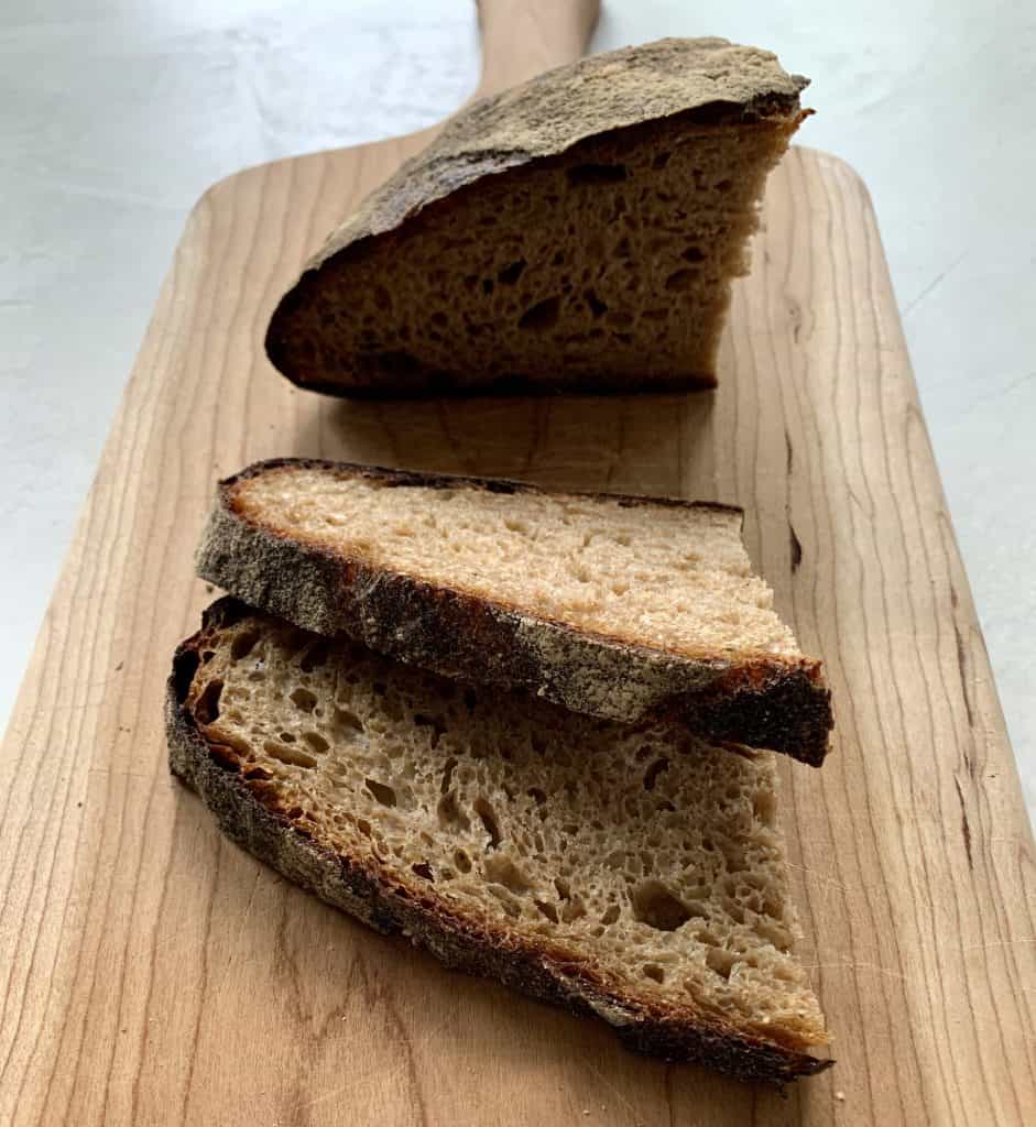 Fresh Bread sliced on wooden cutting board