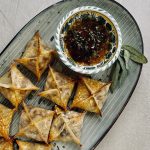 Roasted Butternut Wontons on serving platter with dip